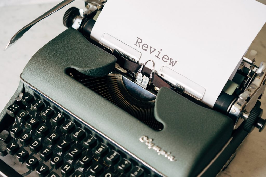Typewriter typing the word "review"